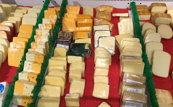 Specialty Cheeses on a red checkered tablecloth. 